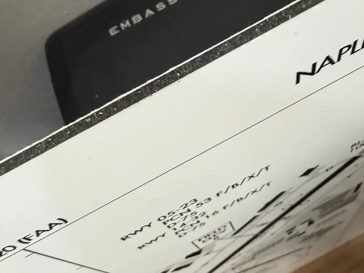 Close-up of the sign edge: white aluminum faces over a dark solid core